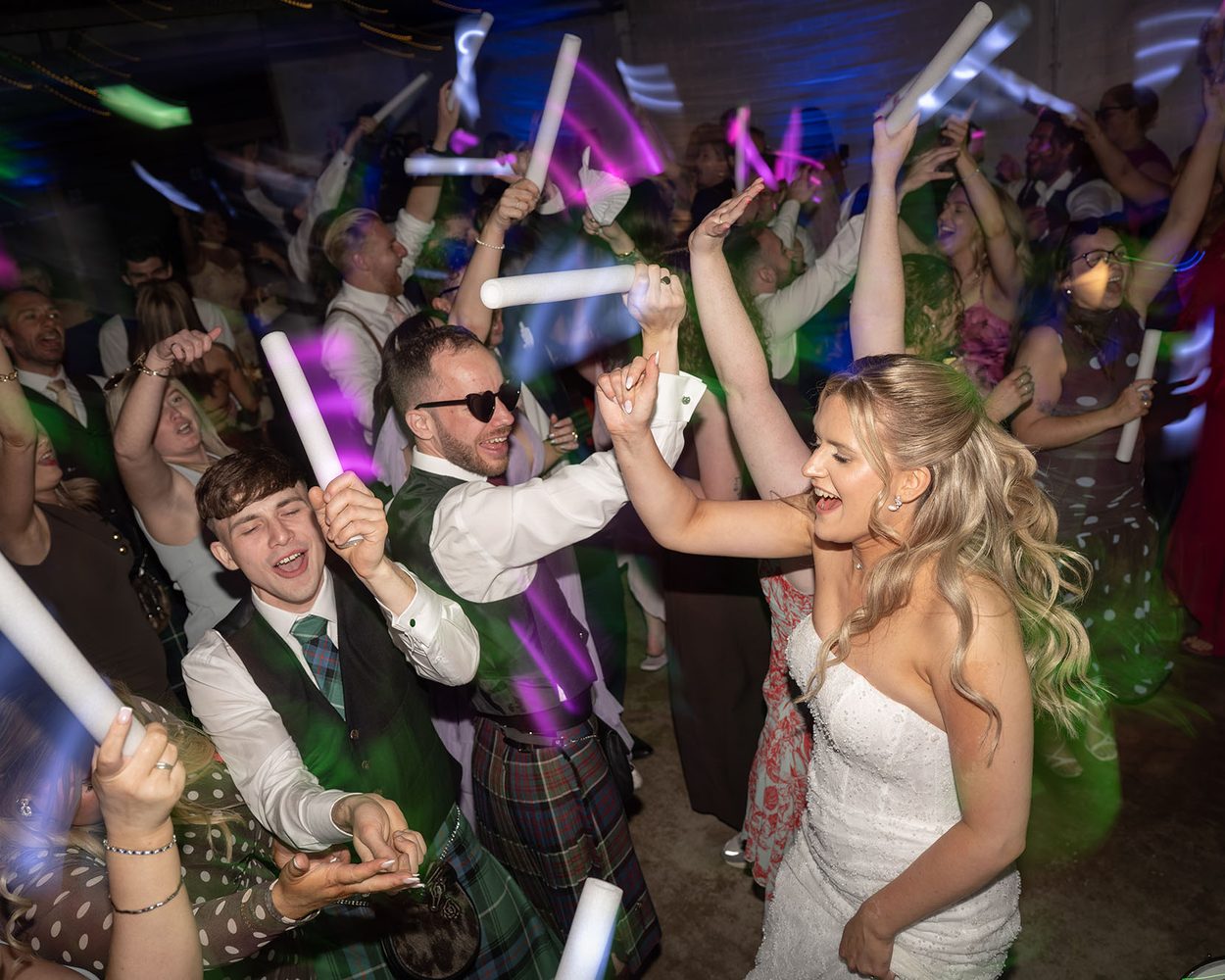 A couple watching fireworks together at their wedding reception